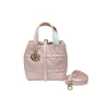 pastel pink luxury Dior tote handbag featuring quilted leather design and contrasting black leather handles.
