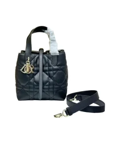 Stylish Black Dior Toujours tote handbag featuring black leather handles and detachable strap.